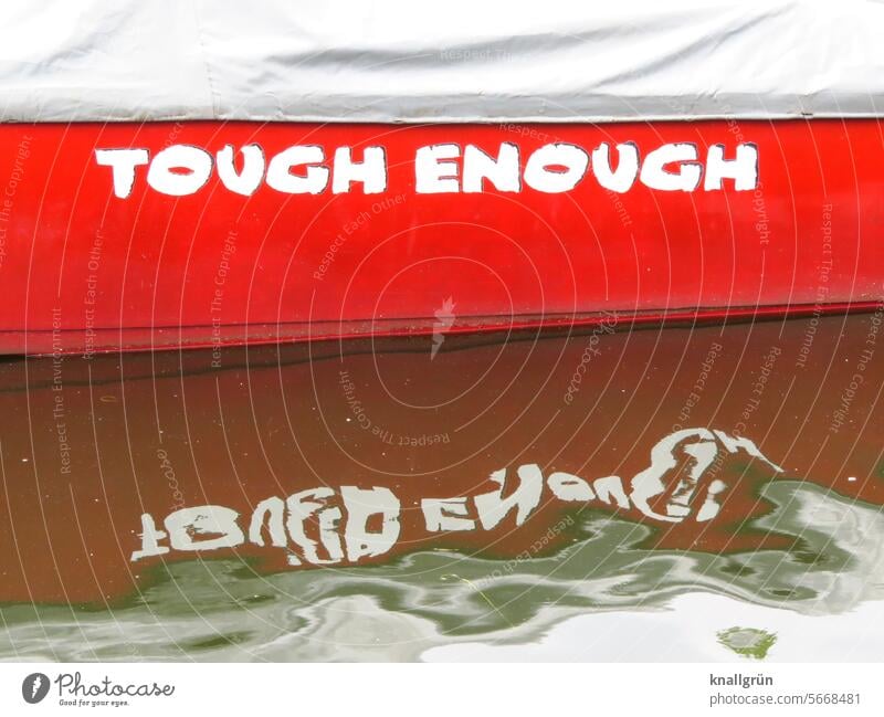 Tough enough boat Water Text boat name English Word Typography Characters Letters (alphabet) writing Signs and labeling Communication communication Colour photo