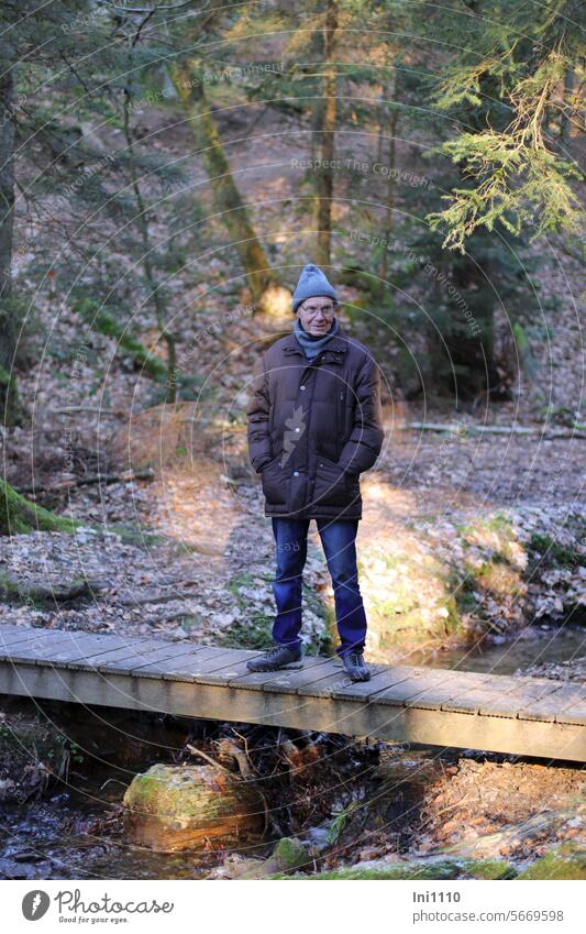 Man on the jetty Winter Human being Senior citizen Stand look Smiling temporise winter clothes warm clothing Cap Scarf winter jacket Light and shadow Valley