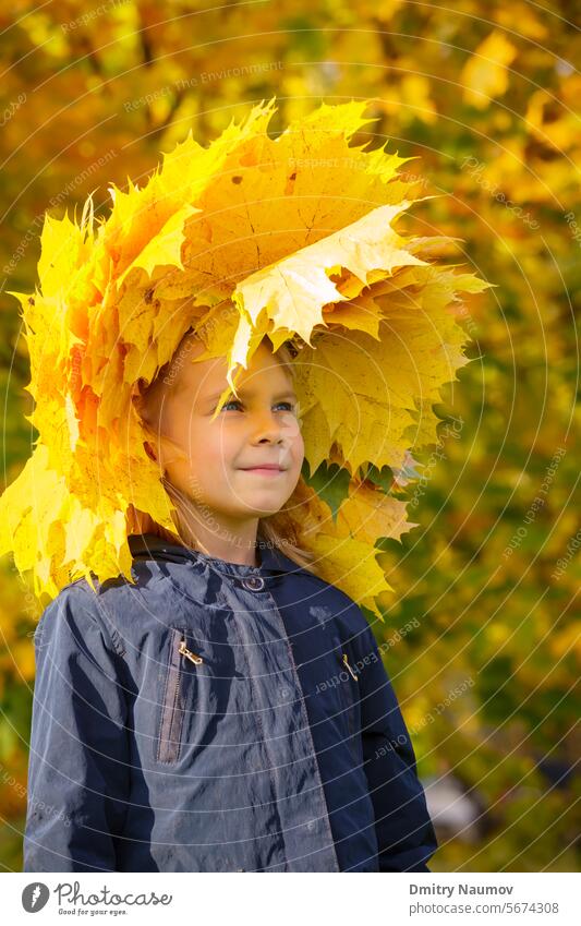 Girl wearing wreath of autumn leaves Facial Expression Real People September Serene People casual caucasian chaplet child childhood countryside cute environment