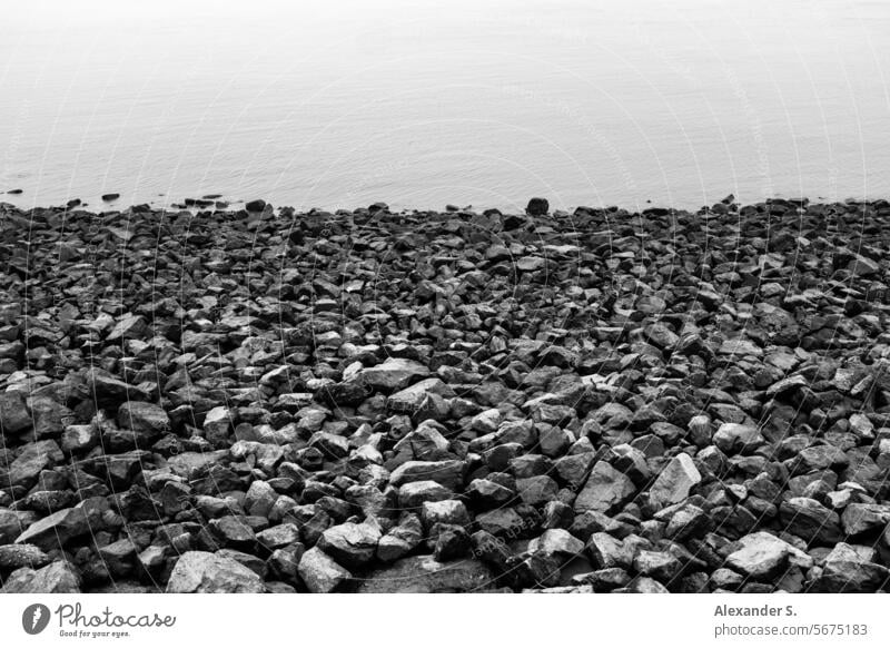 Stone beach on the shore Pebble beach bank Shore line Water Ocean stones gravel graphically Intersection coast Beach Landscape coastline Sea coast Seashore