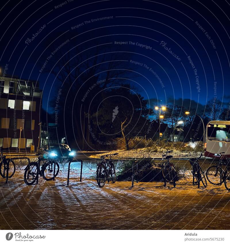 Car and bus in the traffic circle and parked bicycles in the evening Traffic circle Kriesel Street Road traffic Evening Dark Lighting car Bus Floodlight Night