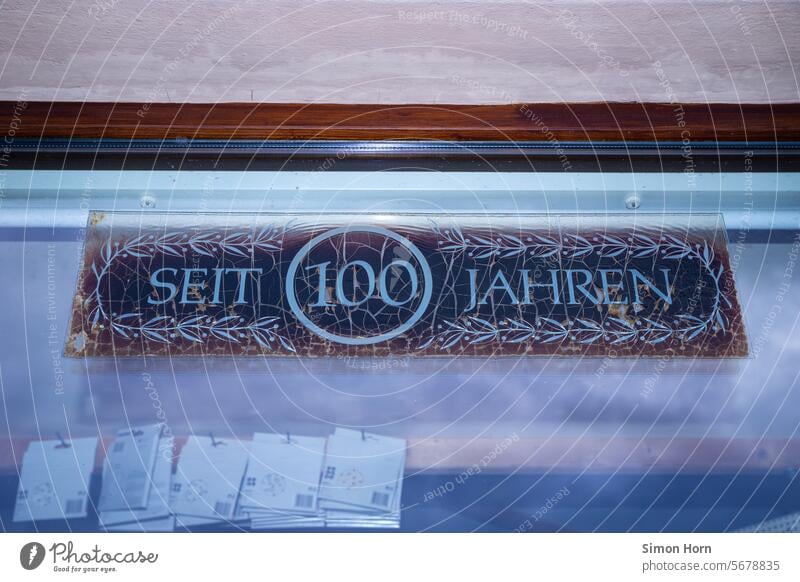 for 100 years, lettering Tradition family-run business Jubilee Digits and numbers Signs and labeling cracked End business discontinuation Time Flake off