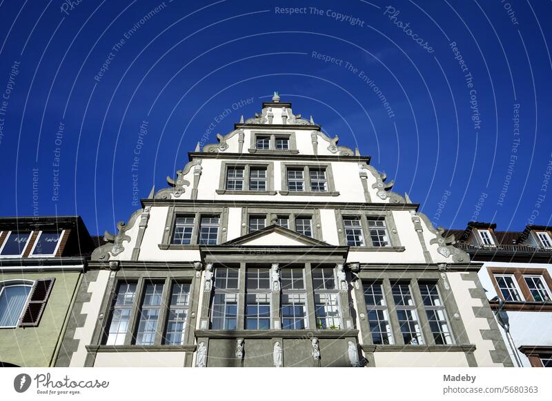 Magnificent old building with ornately decorated gable against a blue sky in the sunshine in the diocese of Paderborn in East Westphalia-Lippe Monument