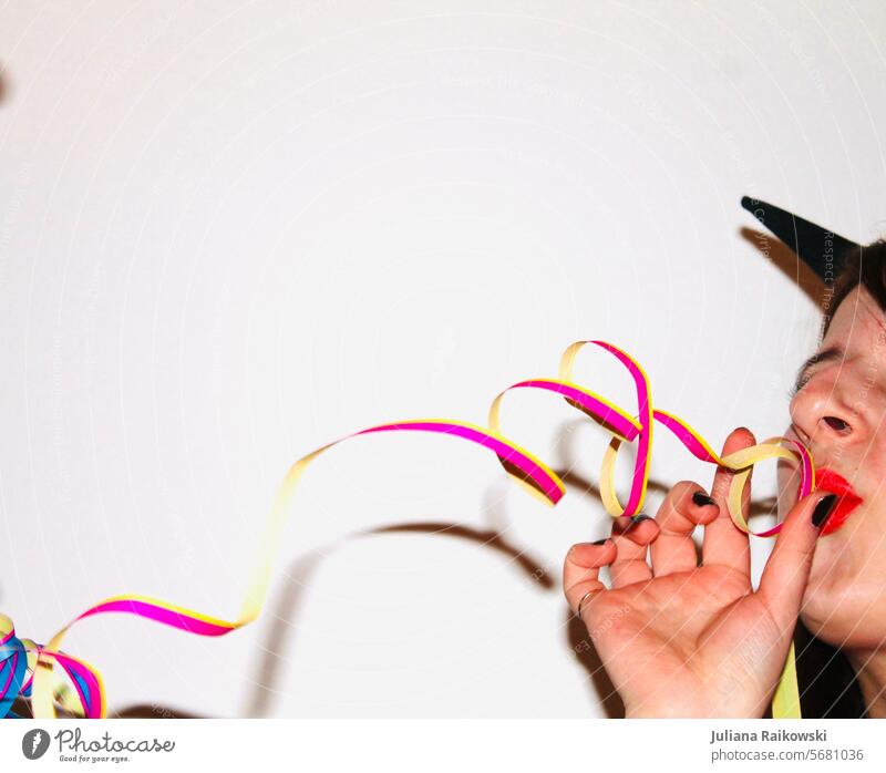 Woman blowing streamers at a party Childrens birthsday Birthday celebrations February Paper streamers Moody Multicoloured Anticipation Paper chain Event