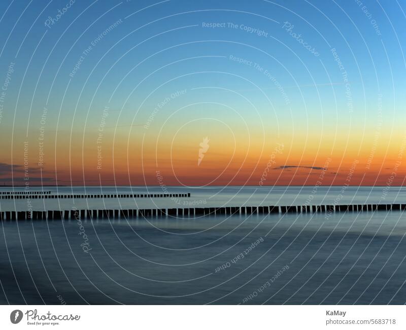 Picturesque colors at sunset over the Baltic Sea in Mecklenburg-Vorpommern, Germany Ocean Landscape coast Copy Space Long exposure Water groynes Sunset Sunrise