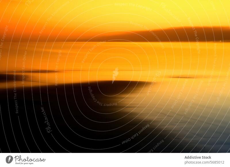 Golden sunset hues over tranquil ocean waters abstract golden orange serene beauty calm sea dusk evening horizon reflection peaceful gradient blend nature warm