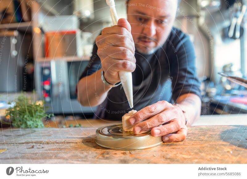 Concentrated man laying cream on cheese dessert chef focus kitchen restaurant tasty concentrate pastry bag italian cuisine kitchenware palatable culinary sweet