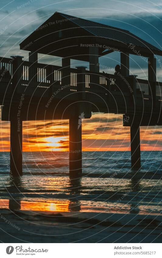 Serene sunset at Miami beach pier with silhouette miami florida usa tranquil golden sky wave ocean serene dusk evening waterfront structure travel tourism