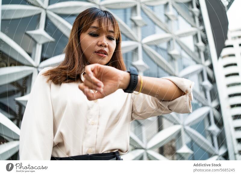 Checking the time during busy day in Chiang Mai woman asian thai businesswoman chiang mai thailand city urban modern architecture watch schedule professional