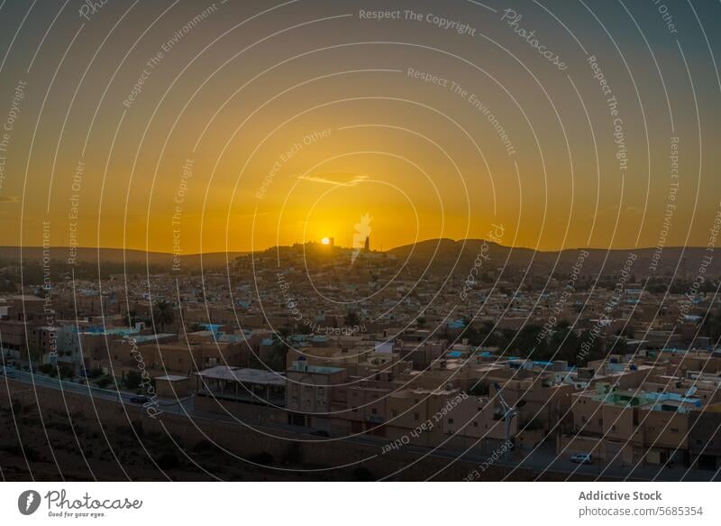 Sunset over Ghardaia's desert cityscape sunset ghardaia skyline warm hues glow buildings serene dusk town architecture urban twilight africa algerian