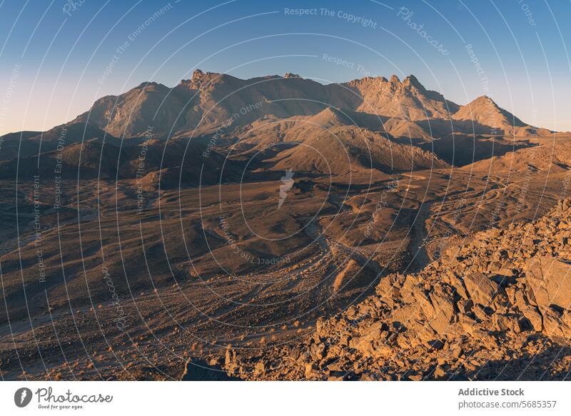 Golden hour over Mount Tazat rugged terrain sunrise mount tazat golden hour rocky outcrop path mountain desert dawn light nature landscape wild remote scenic