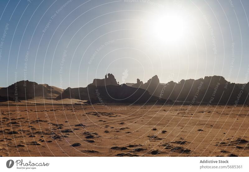 Sunset silhouettes against desert backdrop sunset sahara rock formation natural beauty sky algeria Tin Merzouga africa landscape nature dusk Tadrart Rouge