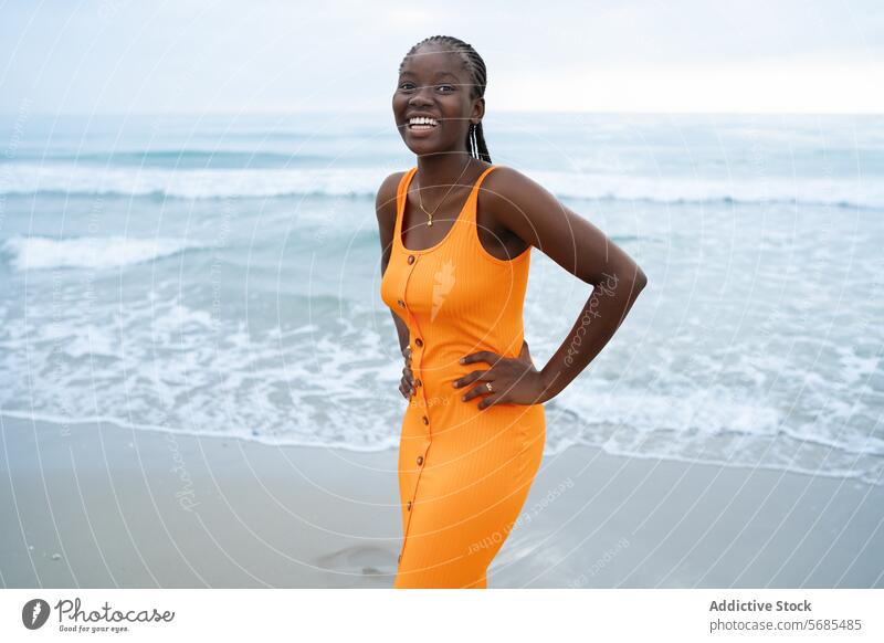 Positive black woman standing on seashore wear necklace style outfit lady positive smile beach ocean vacation female young cheerful accessory happy feminine