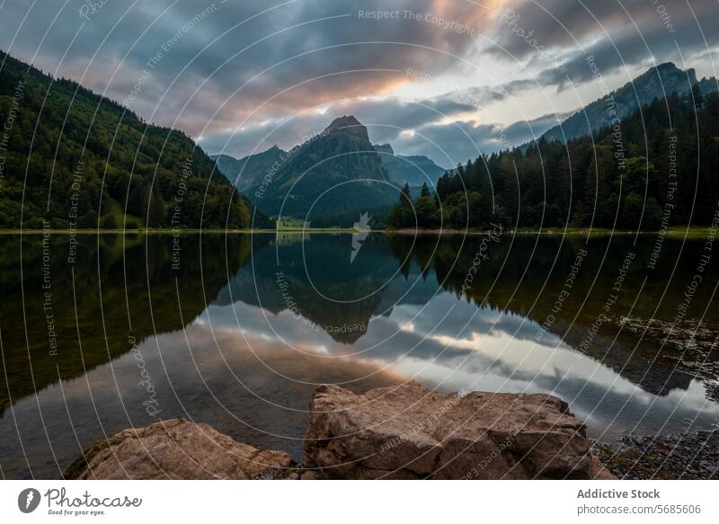 Dusk tranquility at a serene Alpine lake mountain reflection water dusk swiss alps nature landscape sky clouds forest scenery calm switzerland evening twilight