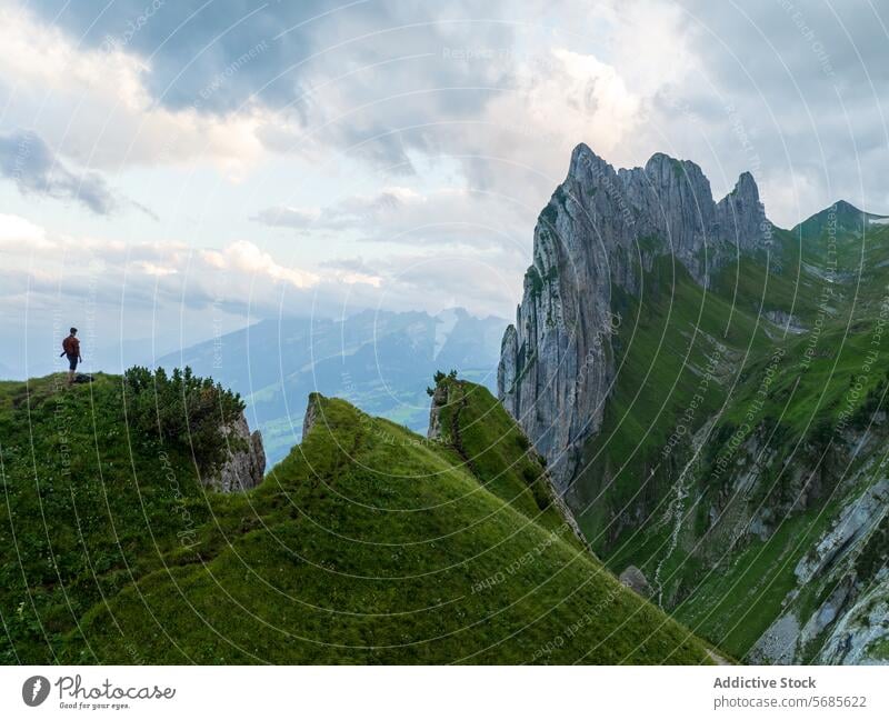 Unrecognizable hiker enjoying scenic view in Appenzell region appenzell switzerland ridge rugged peaks green lush landscape nature outdoor travel adventure