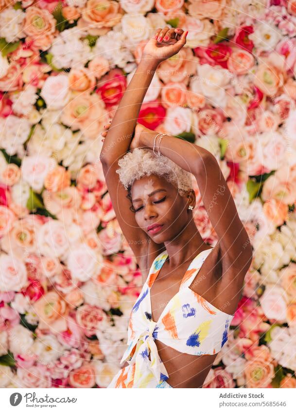 Elegant black woman in stylish summer dress with raised arms flower floral style sensual bloom elegant bouquet young happy smile feminine ornament nature