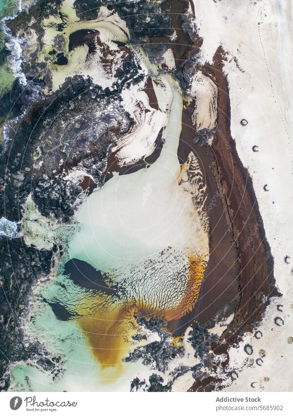 From above aerial image capturing the dramatic interplay of volcanic rock and tidal pools along Fuerteventura north coast, between El Cotillo and Majanicho near Faro del Toston