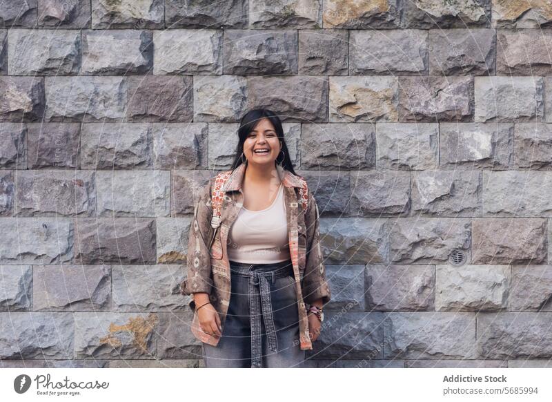 Cheerful woman standing on street smile top jacket positive brick wall cheerful lady confident happy joy young female optimist appearance glad personality