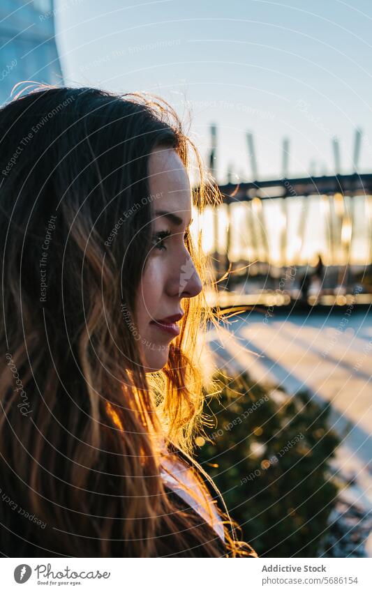 Evening glow on woman in Madrid madrid evening portrait young warm light setting sun pose feature accentuated female beauty dusk twilight golden hour backlit