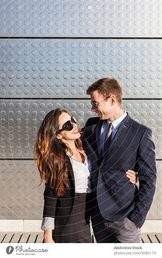 Stylish couple enjoying a sunny day in Madrid madrid spain fashion smile happiness stylish woman love partnership sunglasses suit dress business attire leisure