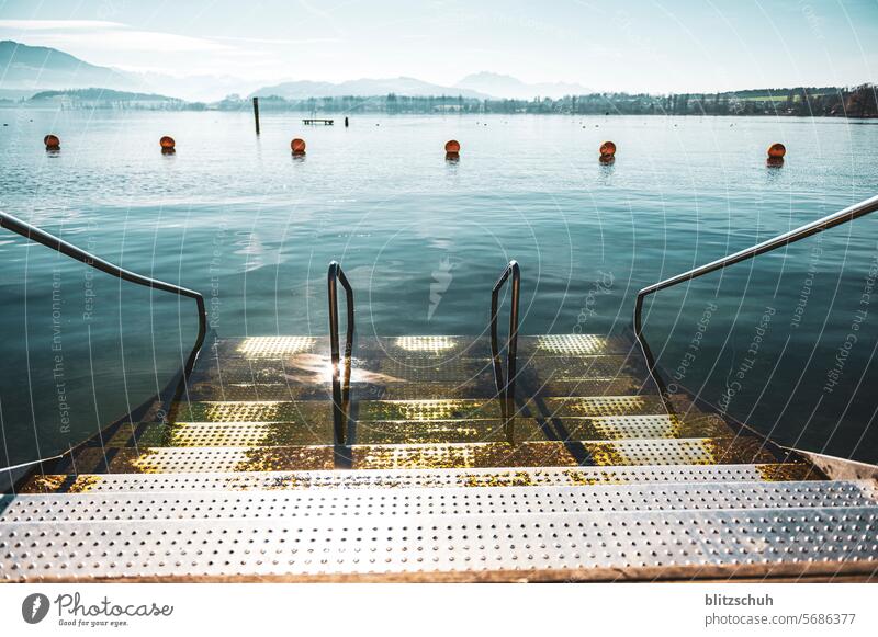 A winter's day at the lake with steps into the water Lake mountains Buoy buoys Water Nature Landscape Lakeside Vacation & Travel Relaxation Tourism Environment