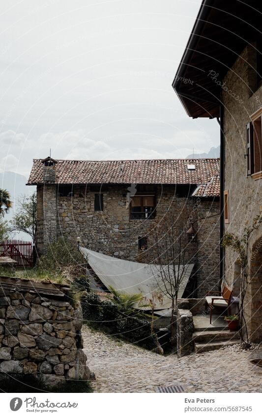 Canale di Tenno, medieval village in Italy Looking mountains Trentino Tourism vacation houses Haze trento Mountain Summer Landscape Nature Lake Sky Water