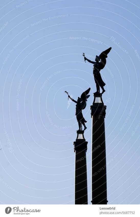 Two angel statues with wings against the blue evening sky Angel angel wings Belief Exterior shot Religion and faith prague angelic Silhouette Statue Day