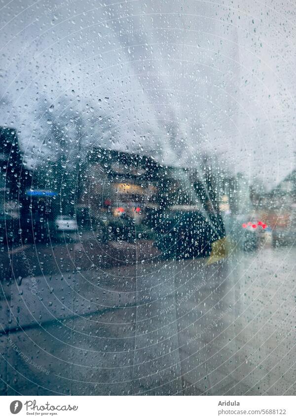 Shopping street reflected in window pane with raindrops Slice Window Window pane Rain Wet Drops of water Bad weather Rainy weather Gray Dreary houses Street off