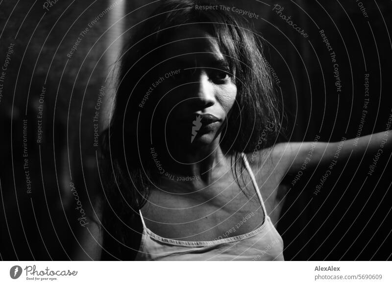 Young, long-haired woman supports herself behind a transparent curtain/net in the semi-darkness Woman Young woman Long-haired Dark Black black-and-white Net