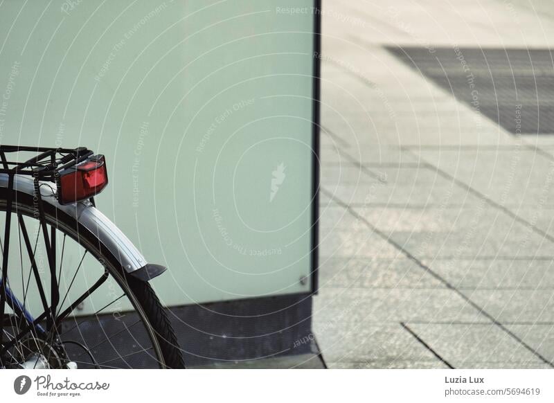 Rear wheel of a bicycle, red rear light Gloomy Old Town Parking Bicycle tyre Close-up Detail Mobility Tire Wheel Means of transport Cycling Day Exterior shot