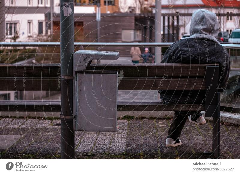 Seated young man in the city Man Young man Sit sedentary Youth (Young adults) Human being 18 - 30 years Exterior shot Shallow depth of field tranquillity