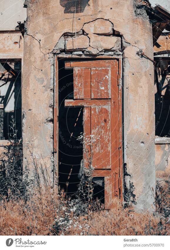 old broken wooden door of a destroyed house in Ukraine access architecture background brown building buried city close color conflict design dirty door handle