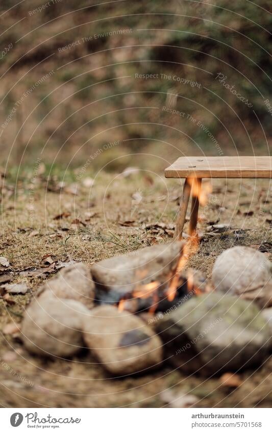 Campfire with dry wood in a stone circle in nature campfire Camp fire atmosphere Stone stones Meadow Nature Experiencing nature Love of nature Fire Fireplace