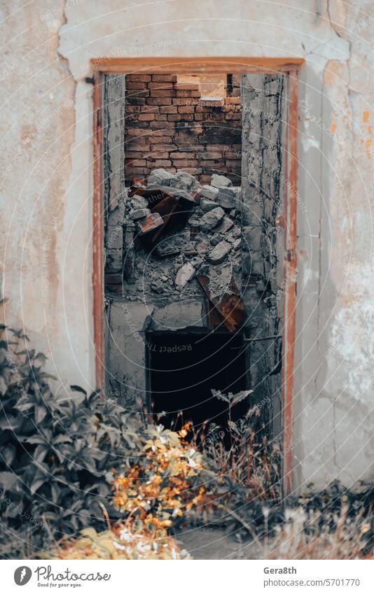 old broken door of a destroyed house in Ukraine access architecture background brown building buried city close color conflict design dirty door handle