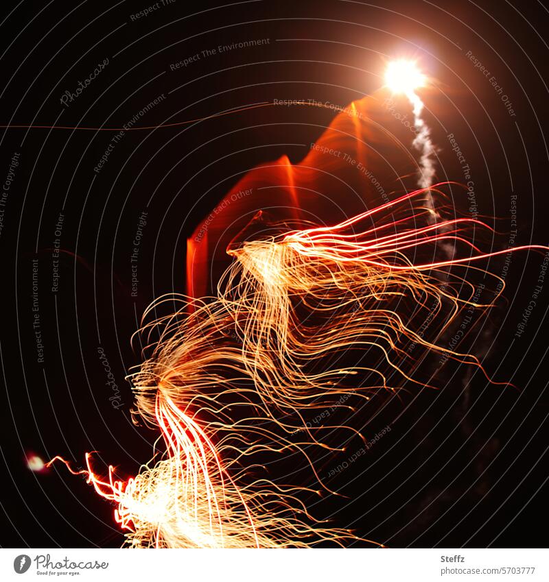 Flying sparks in the night sky flying sparks Spark Abstract Energy Firecracker abstraction Illuminate celebration Light transmitting lighting effects Ease