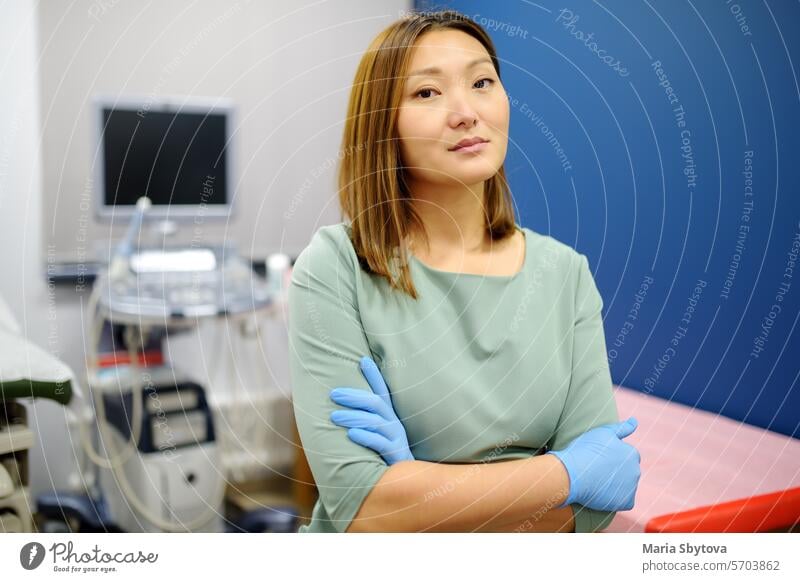 Portrait of asian female obstetrician gynecologist in office during work. Professional and responsible doctor working in a modern clinic of city portrait Asian