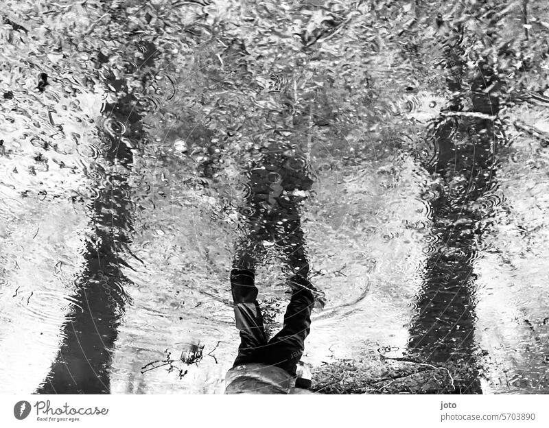 Reflection of a child in a puddle on a rainy day Puddle reflection Reflection in the water rainy weather Autumn Autumnal autumn atmosphere Black & white photo