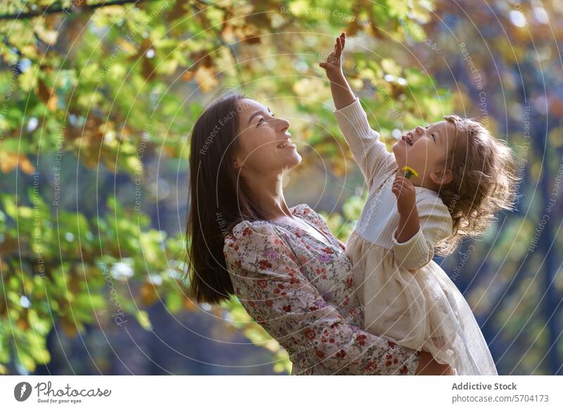 Ethnic mother and daughter bonding in sunny Californian park nature california ethnic family joy happiness childhood parenting motherhood love playful outdoors