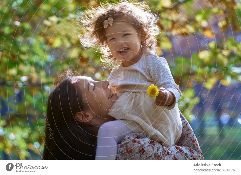 Joyful Ethnic Mother and Daughter in California Park mother daughter family joy happiness nature park california ethnic bonding love outdoors sunlight playful