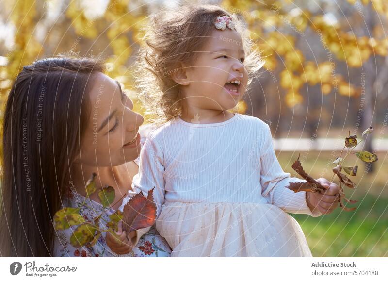 Mother and Daughter Bonding in Autumnal California Park mother daughter ethnic bonding nature park california autumn joy family parent child female happiness