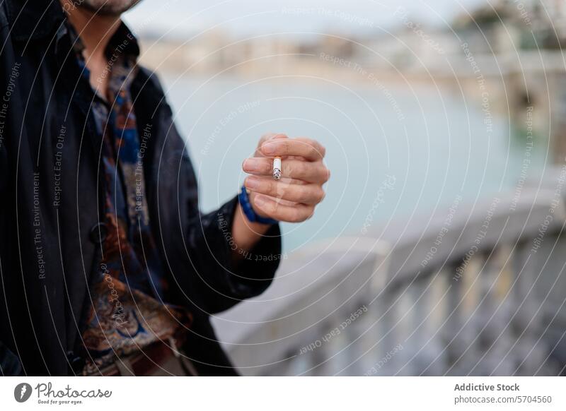 Man showcasing a ring by the seaside man hand style fashion jewelry accessory presentation blurred background elegance close-up male showing showcase grip