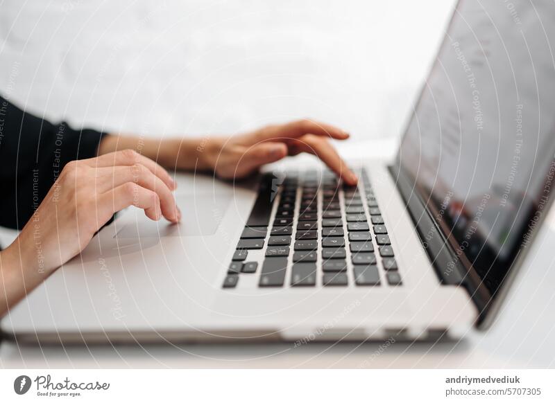 Close up woman's hands typing on laptop keyboard at home office. Businesswoman or student girl using pc for online internet marketing, freelance, work from home, education online, distance studying