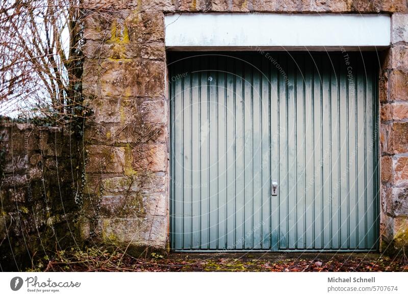 Old garage in even older walls Garage Garage door Highway ramp (entrance) Goal Gloomy Highway ramp (exit) Closed Building Architecture Gray Parking Masonry