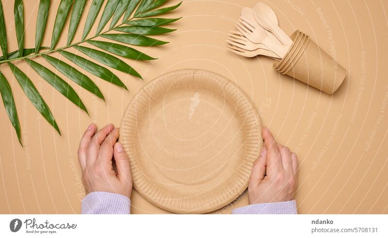 Paper plates and cups on a beige background ecological spoon concept food wooden fork tableware disposable paper bamboo organic picnic utensil dish cutlery set