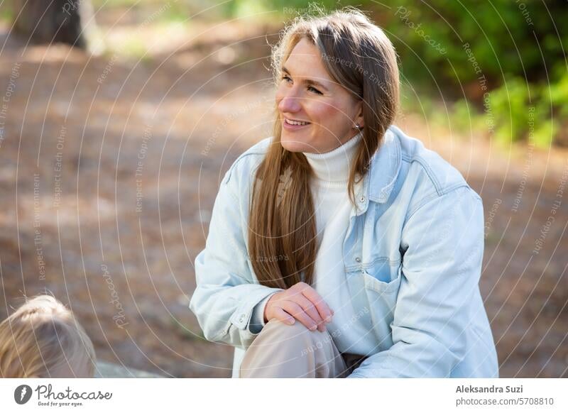 The mother with two children is having a fun time at the playground. Two little boys with their mom playing in the sandbox active activity care casual caucasian