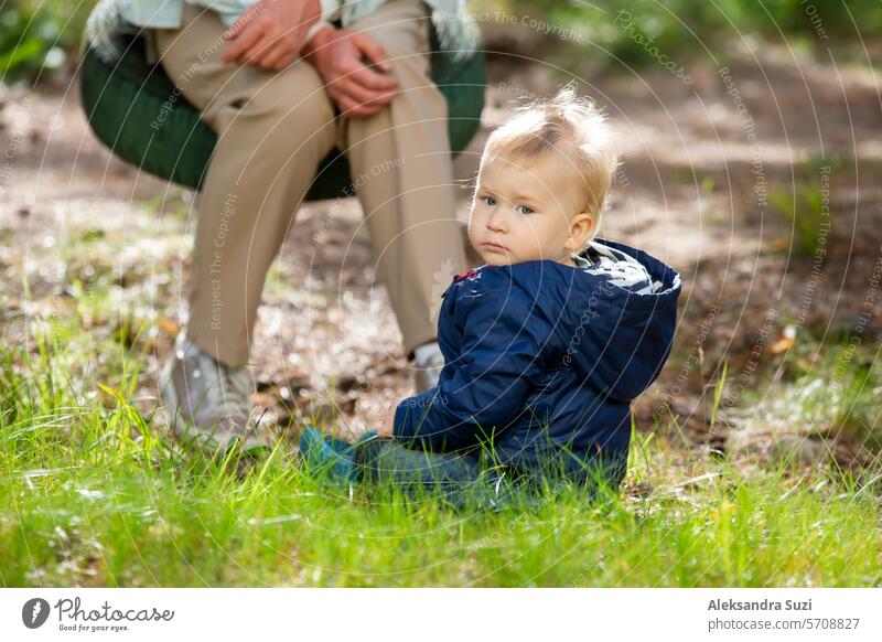 The mother with two children is having a fun time at the playground. The mother is swinging her children on the swings. active activity baby boy care caucasian