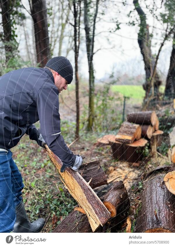 A man works in the garden | tree felling | small wood Logging Tree Timber Stack Annual ring Tree section Cut Brown structure bark Tree bark stacked Man