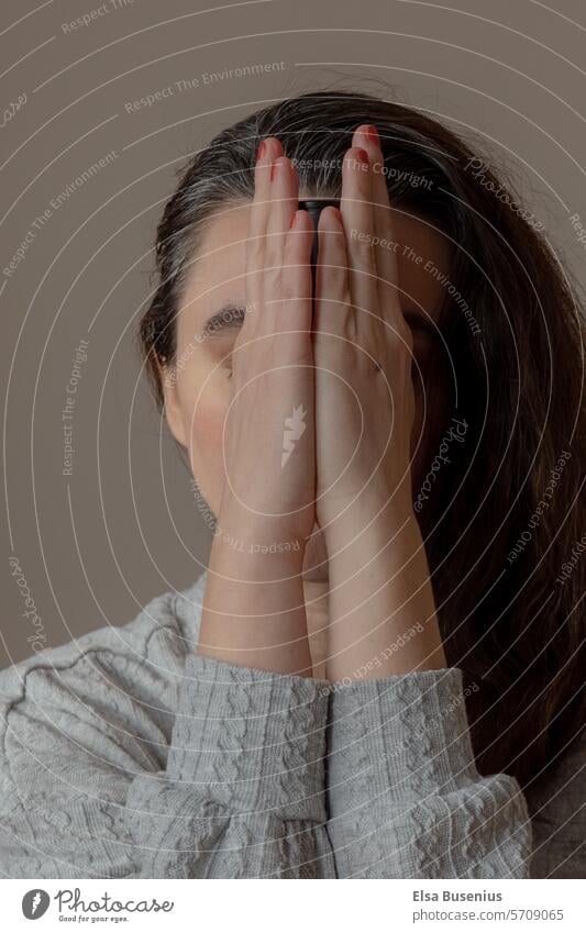 Hands in front of the face indoors dark hair middle age eyes closed Woman Human being ying yang dark light pray Peaceful Think think Distress