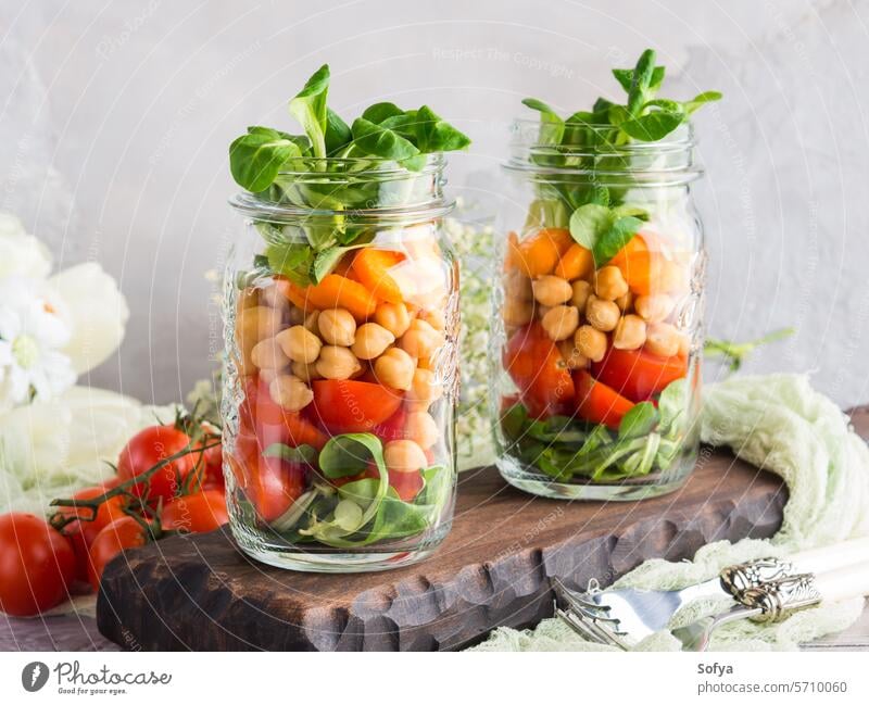 Fresh salad lunch served in mason jars food healthy chickpea fresh carrot glass homemade organic herb vegetable vegetarian ingredient snack vegan wooden