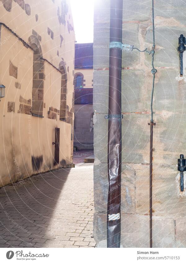 Passage between old buildings of a monastery backlit by the sun Monastery Church Sunbeam Vintage Historic Religion and faith Back-light Alley Tourist Attraction